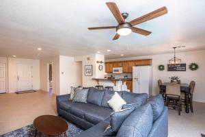 a living room with a blue couch and a ceiling fan at Relax and Unwind - Pool - New - Central - Spacious in Lake Havasu City
