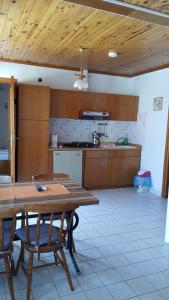 a kitchen with a wooden table and chairs in a room at Delphin Hotel Side in Side