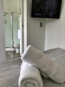 a bathroom with a towel laying on a bed at Horlock House in New Town