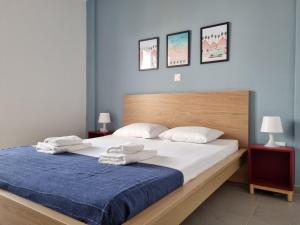 a bedroom with a large bed with two towels on it at Tefkrou Anthia 9 apts in Ayia Napa