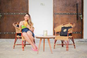 a woman in a bikini sitting in a chair at Jungle Baum Villa Habarana in Hiriwadunna +11 photos