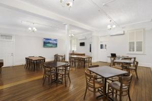 a dining room with tables and chairs in it at Central Hotel Stroud in Stroud