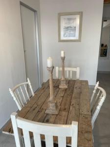 a wooden table with two candles on top of it at Whale Rock in Cape Town