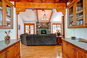 
a kitchen with wood floors and a large window at Ahwahnichi Lodge in Yosemite West
