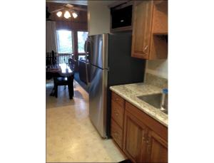 a kitchen with a stainless steel refrigerator and wooden cabinets at Chateau Royal East in Yosemite West