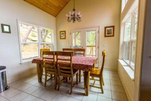 a dining room with a table and chairs and windows at Birds Eye Vista in Yosemite West