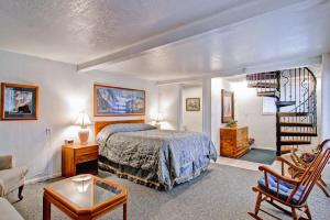 a bedroom with a bed and a spiral staircase at Chateau Royal East in Yosemite West