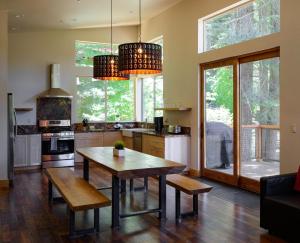 a kitchen with a wooden table and chairs and windows at Alpenglow 2 in Yosemite West