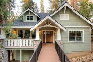 a house with a front porch with a walkway at Craftsman Cottage in Yosemite West
