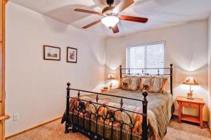a bedroom with a bed with a ceiling fan at Bears Den & Little Bear in Yosemite West