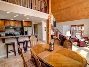 a kitchen and living room with a table and chairs at Alpine Aerie in Yosemite West