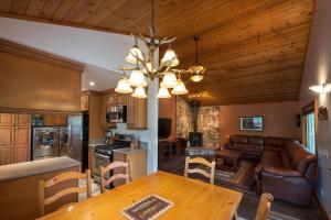 a kitchen and living room with a table and a couch at Fishermen’s Oasis in Oakhurst