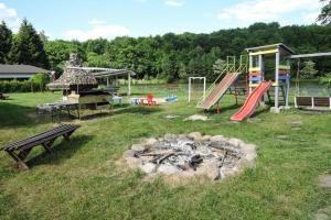 a park with a playground and a fire pit at holiday home, Szczecin in Szczecin