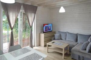 a living room with a couch and a tv at Terraced Houses, Dziwnow in Dziwnów