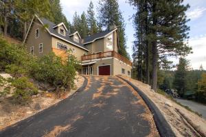 a house with a clock on the side of a road at Kildrummy Lodge in Yosemite West