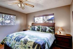 a bedroom with a bed and a ceiling fan at Lazy Bear Lodge in Oakhurst