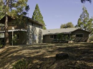 a house with a large yard in front of it at Lazy Bear Lodge in Oakhurst