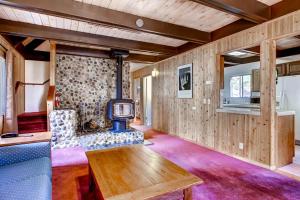 a living room with a tv and a table at Skyline Retreat in Yosemite West