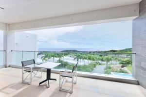 a dining room with a view of the ocean at Crystal Villa Imgya in Miyako-jima