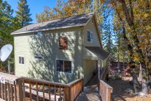 a tiny house with a porch and a deck at Yosemite Park Place in Yosemite West
