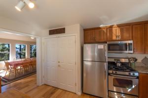 a kitchen with a stainless steel refrigerator and a dining room at Yosemite Park Place in Yosemite West +10 photos
