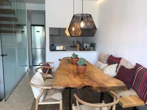 a living room with a wooden table and a couch at Ponent Formentera in La Savina