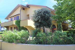 a building with a lot of plants in front of it at Amanda Appartamenti in Lido Adriano