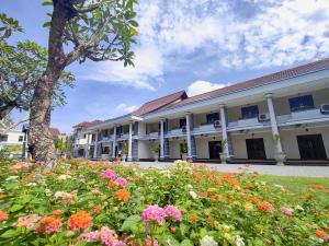 a building with flowers in front of it at Crystal City Hotel in Mataram