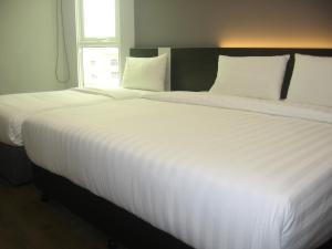 Postel nebo postele na pokoji v ubytování 707 Hotel (Cheng Ho ) Melaka