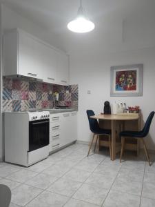 a kitchen with a table and a stove top oven at Lux apartment downtown in Serres