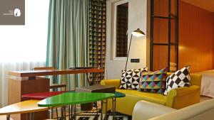 a hotel room with a couch and a table at Hotel The Designers Hongdae in Seoul