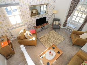 an overhead view of a living room with a television at Crown Cottage in Tenby