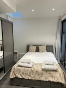 a bedroom with a bed with two towels on it at 4 Islington Park Street in London