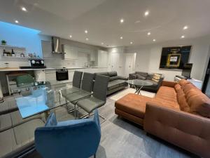 a living room with a couch and chairs and a table at 4 Islington Park Street in London