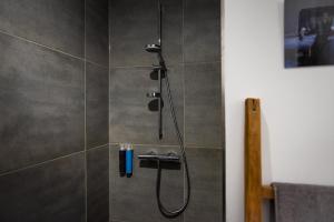 a shower with a shower head in a bathroom at Urbn Dreams II in Berlin +70 photos