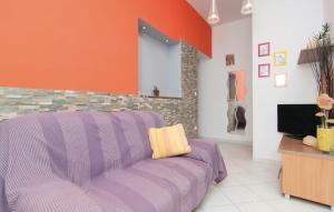 salon z fioletową kanapą i telewizorem w obiekcie Apartments Roko w mieście Jesenice