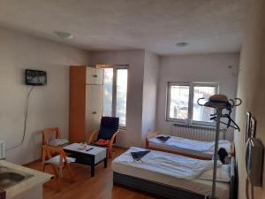 a bedroom with a bed and a table and a chair at Guest House Gina in Ohrid