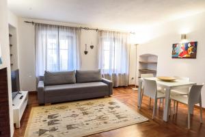 a living room with a couch and a table at DeTillierStudiò in Aosta
