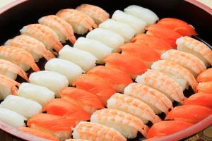 a pan filled with different types of sushi at Boso Shirahama Umisato Hotel in Minamiboso