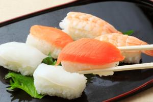 a plate of sushi with salmon and rice at Boso Shirahama Umisato Hotel in Minamiboso