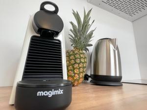 a pineapple sitting next to a coffee maker and a blender at Demeure Rossini Cholet Centre in Cholet