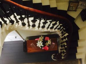a stairway with a wooden table with flowers on it at Broomhouse Farmhouse in Cheswick