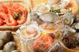 a bunch of seafood on plates on a table at Boso Shirahama Umisato Hotel in Minamiboso +76 photos