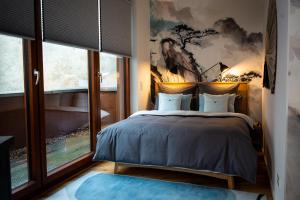 a bedroom with a bed with a painting on the wall at Urbn Dreams II in Berlin