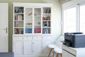 a white hutch with books in it in a room at The Skyward Flats in Nea Smyrni