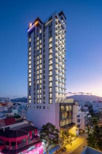 a tall building with lights on top of it at Miracle Luxury Nha Trang in Nha Trang