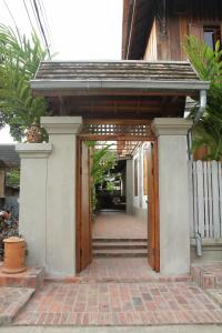 an entrance to a building with a wooden door at Sala Prabang Hotel in Luang Prabang