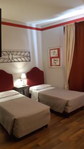 a hotel room with two beds in a room at Albergo Moderno in Lucca