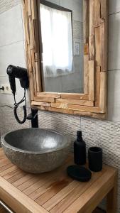 a bathroom with a large stone tub on a wooden counter at Complejo Rural Rincón del Paraíso in Valencia del Mombuey