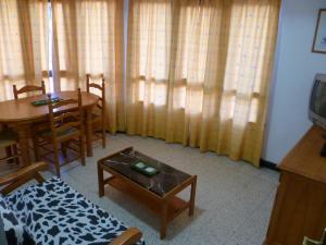 a living room with a table and a dining room at Estirpe, 3º-5 in Cullera